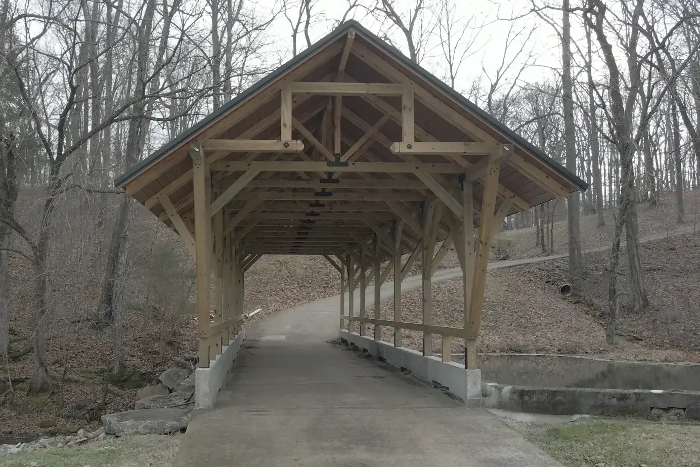 Covered bridge by day before outdoor lighting design