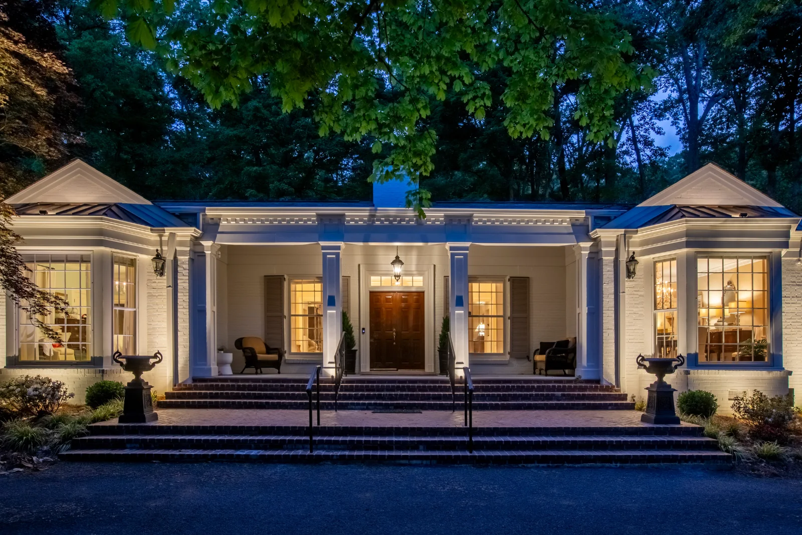 Estate front facade with layered landscape and architectural lighting