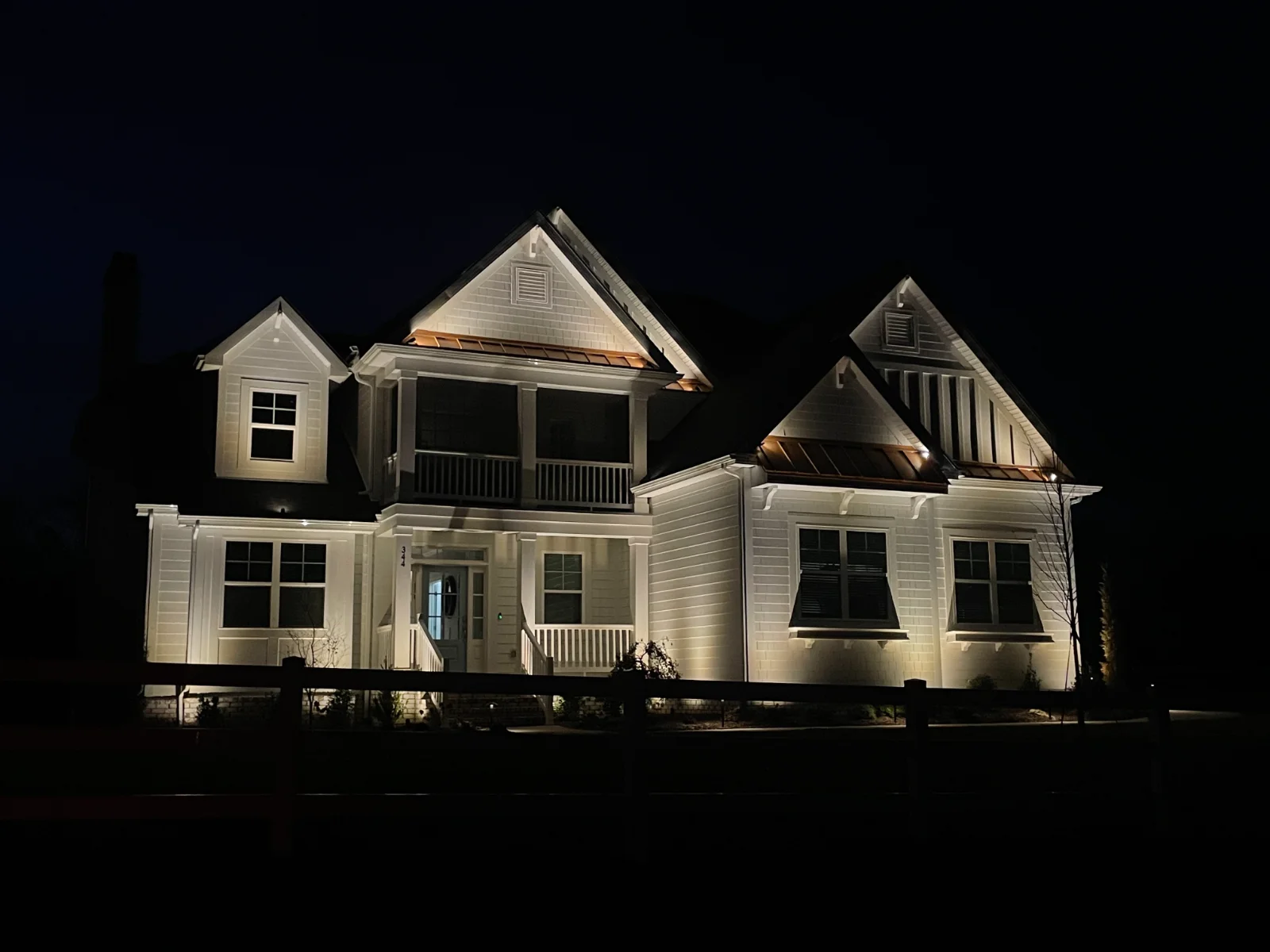 Programmable roofline lighting with architectural up-lighting on a Mount Juliet home at night