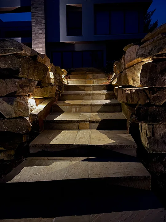 Warm step and boulder wall lighting on stone staircase at night, Mount Juliet