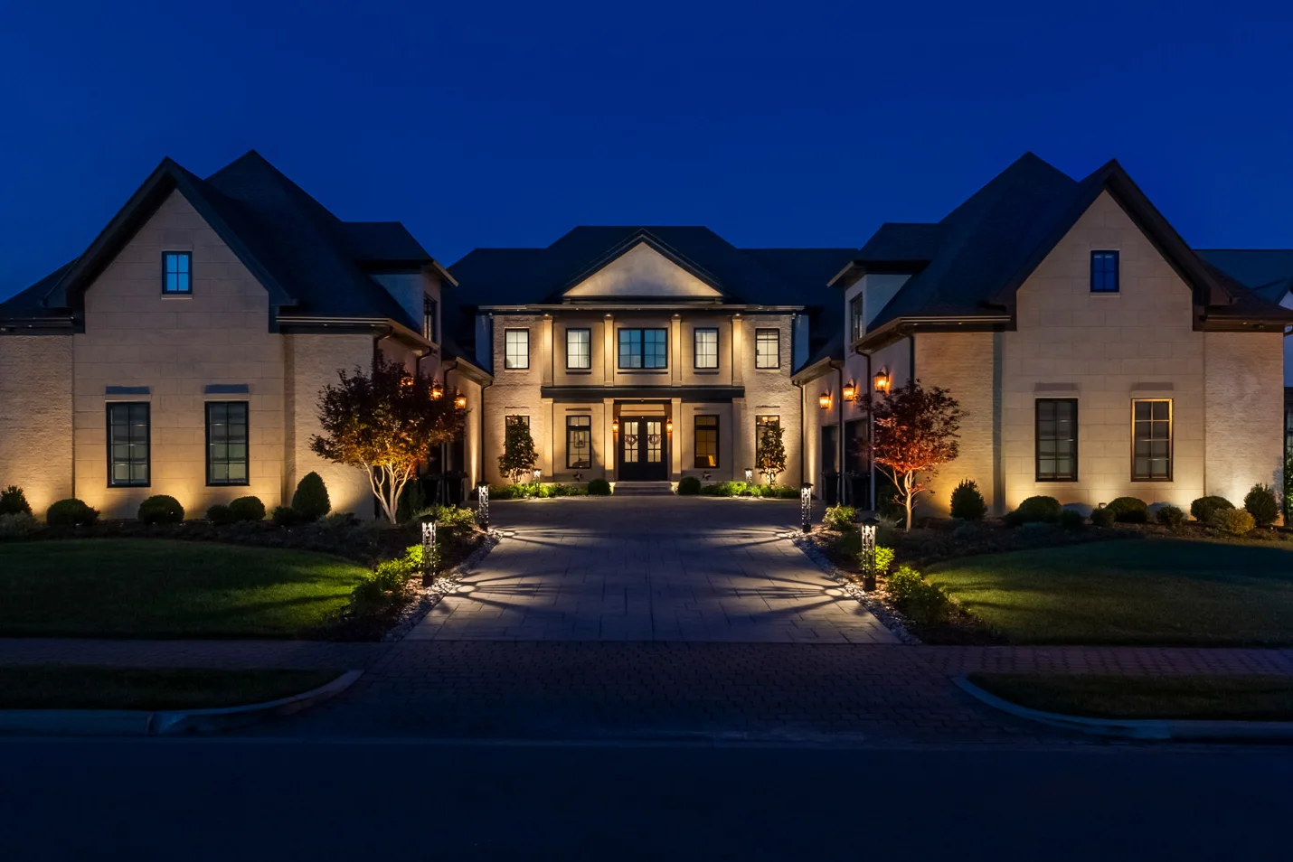 Layered outdoor lighting ideas on a Middle Tennessee estate facade at night, designed by Light TN