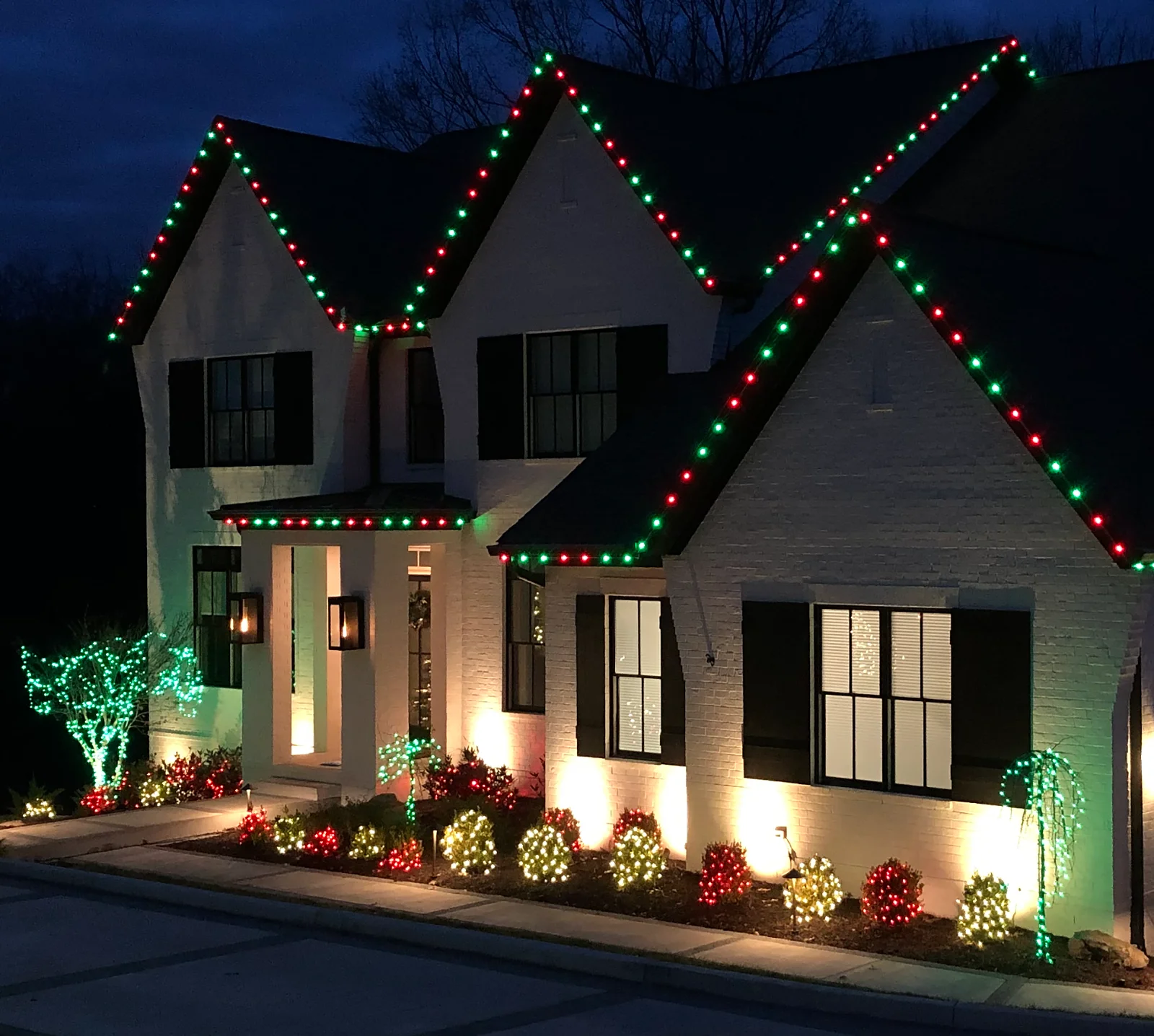 Middle Tennessee permanent roofline holiday lighting with red and green roof lights and landscape accents by Light TN