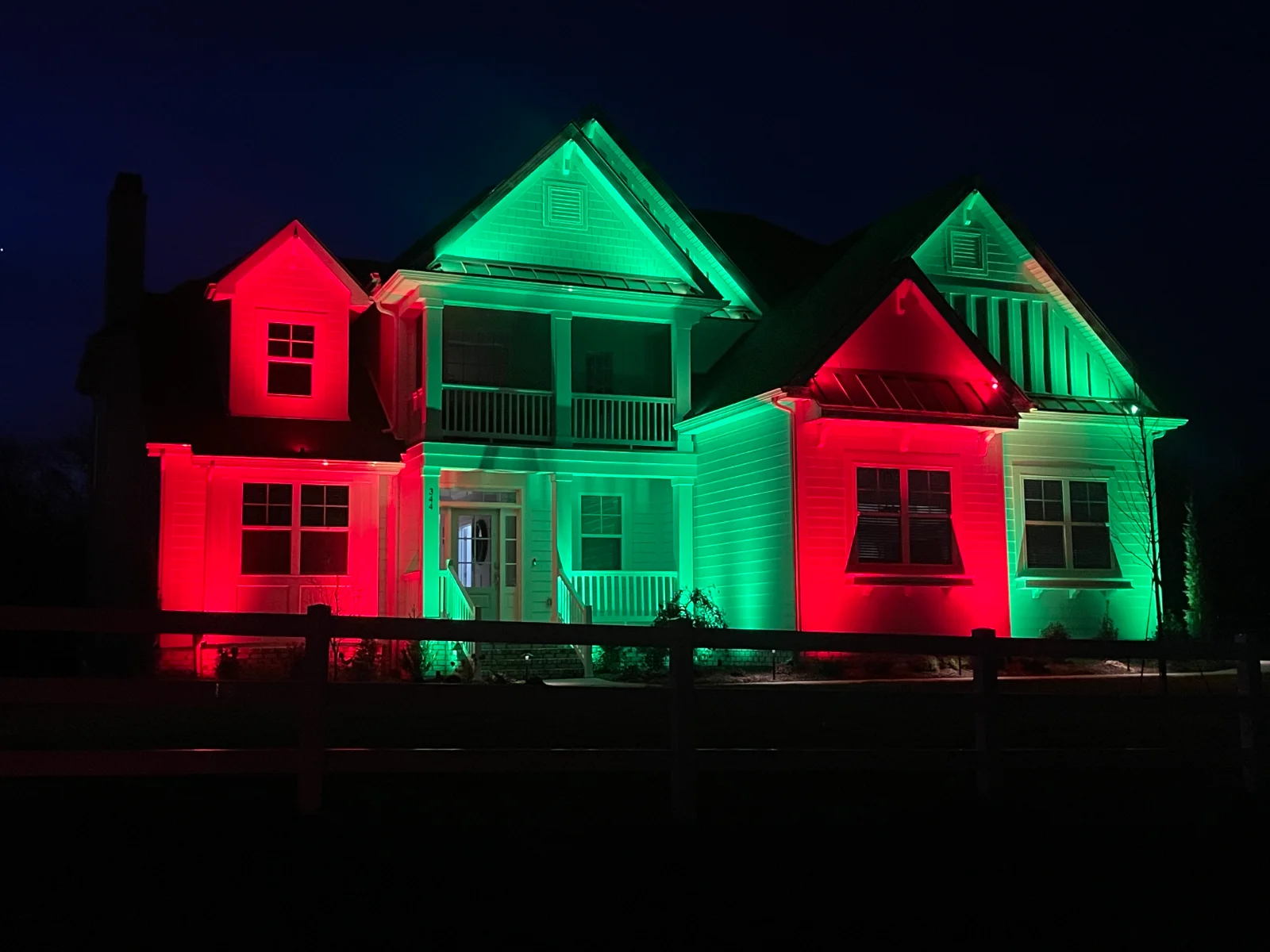 Colorful architectural lighting on Middle Tennessee home with red and green roofline and facade lighting by Light TN